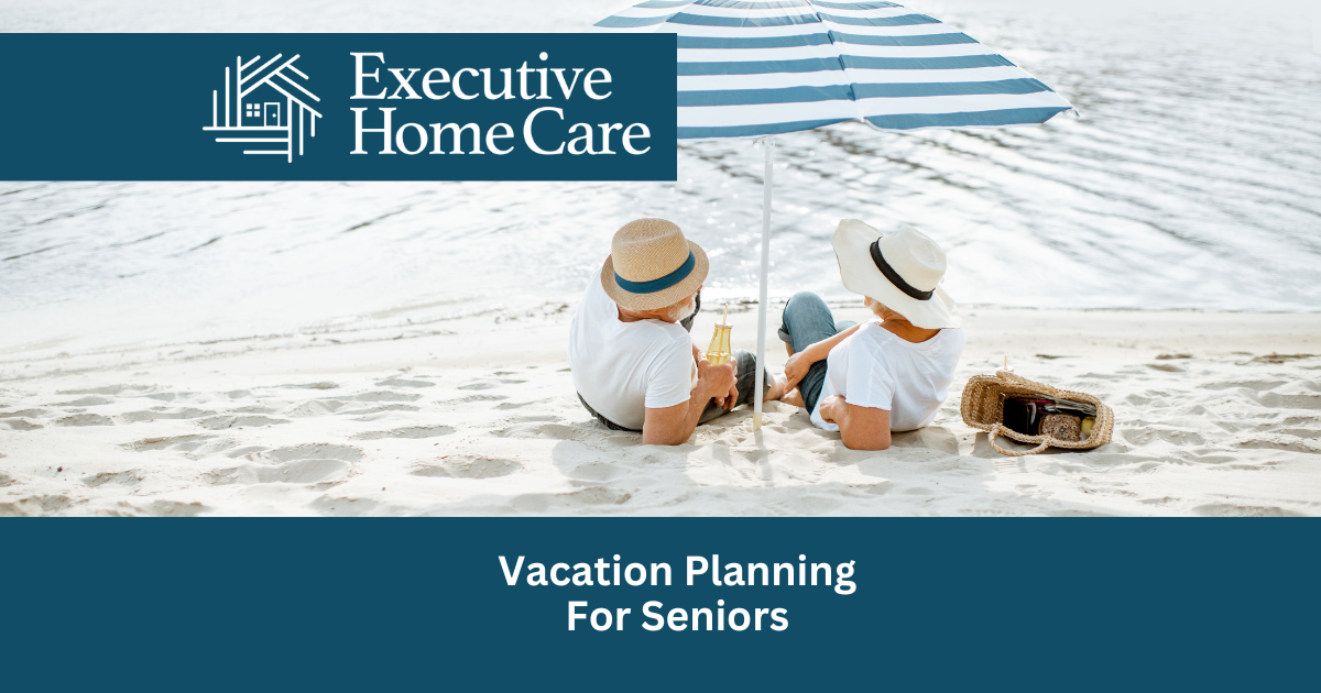 two elderly people laying on a beach under an umbrella
